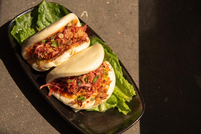 Buttermilk fried chicken, Asian coleslaw, green onion, and spicy aioli served on a fluffy steamed bun.