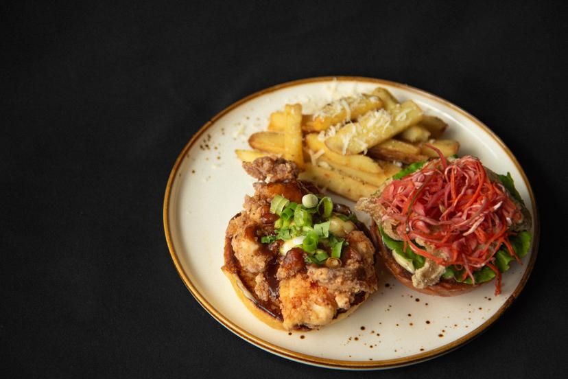 Buttermilk fried chicken, crispy chicken skin, Asian coleslaw, green onion, saw leaves, homemade spicy aioli, homemade Pad Thai sauce on a brioche bun. Served with parmesan fries.