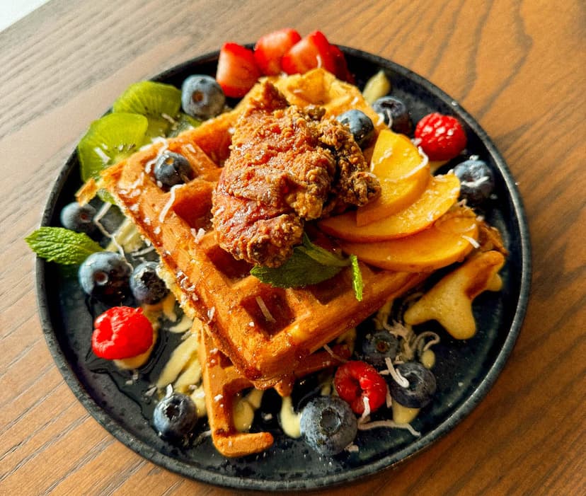 Homemade Belgian wafffle, buttermilk fried chicken, served with seasonal fruits, mixed berries, maple syrup, anglaise sauce, and honey.