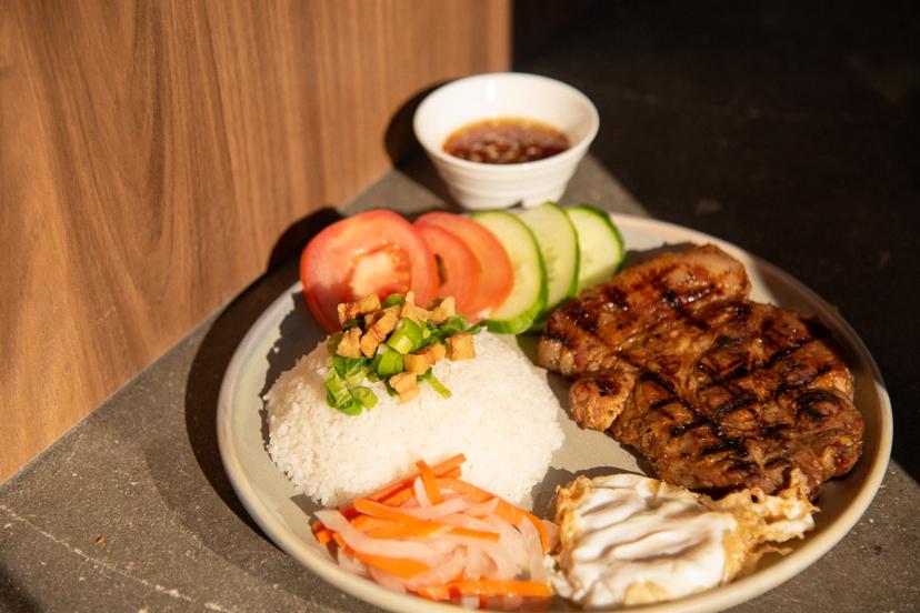 Broken rice served with grilled pork or chicken, sunny-side-up egg, homemade pickled veggies, tomato, and cucumber served with homemade savoury sauce.